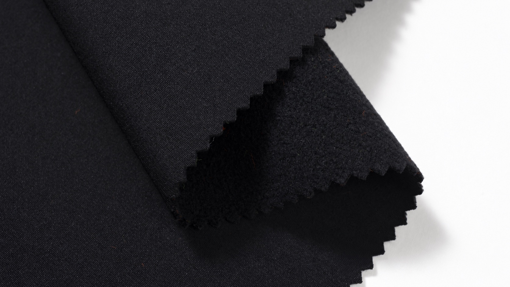 Dark HM025 stretch laminated fabric sample showing the face and backing